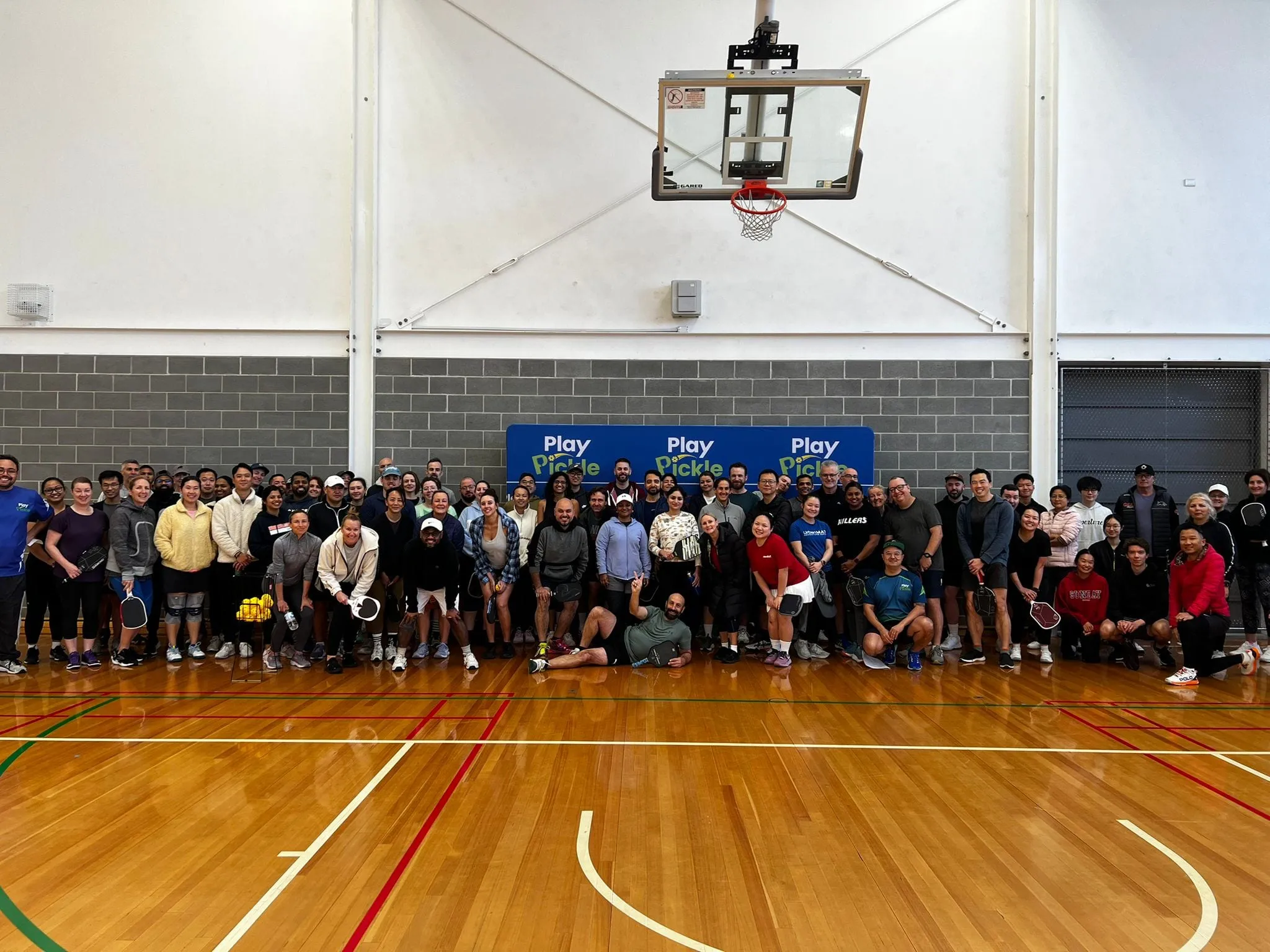 A large group of players gathered on an indoor court